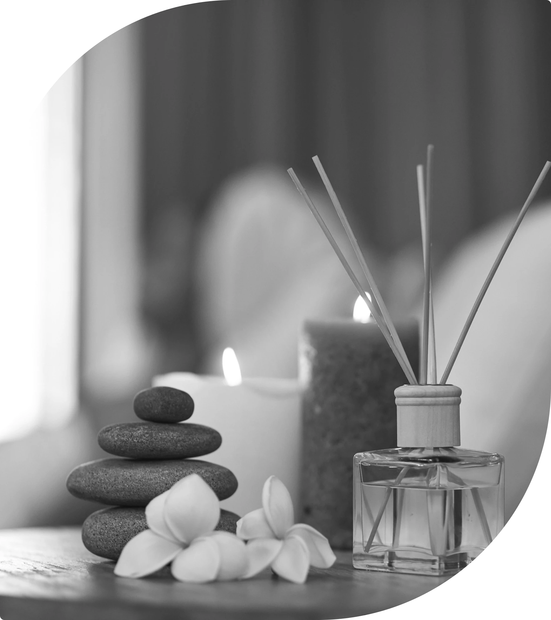Spa setting with candles and aroma sticks.