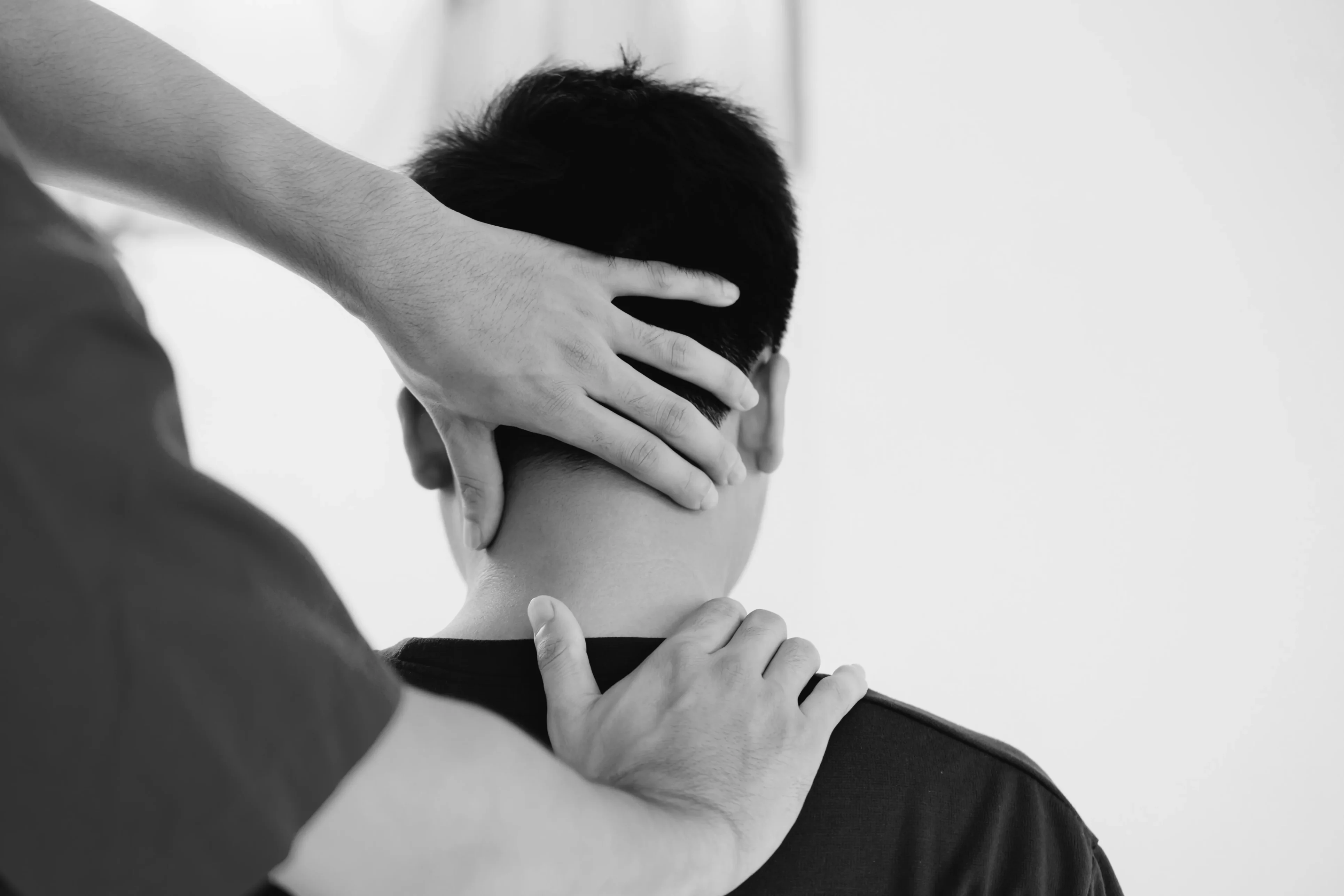 A person is holding another persons hand over their neck.