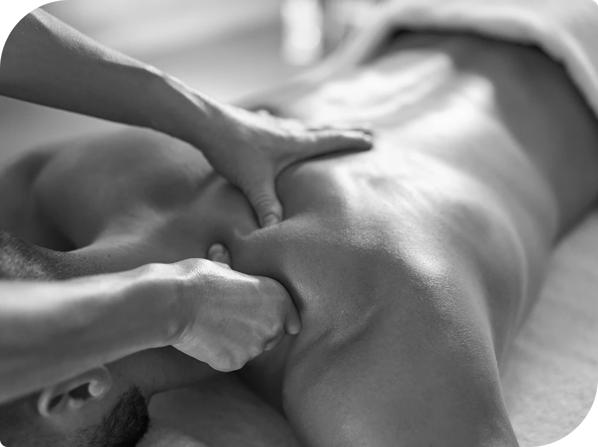 Person receiving a back massage, black and white.